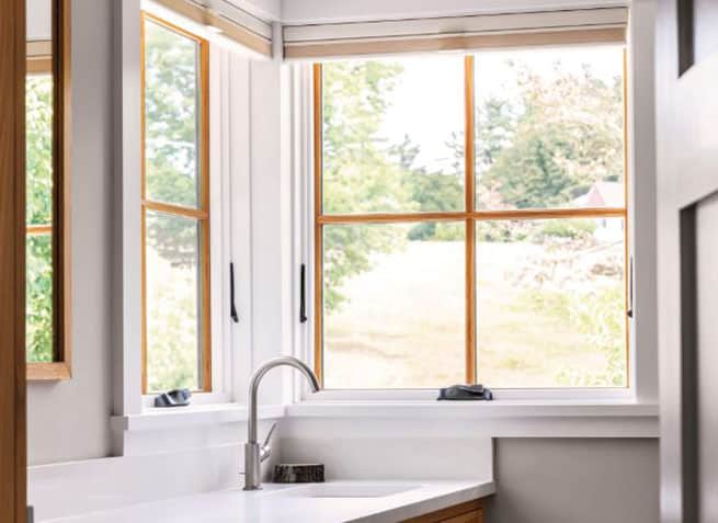 The modern bathroom of a Minnesotan home featuring elevate series awning and picture windows installed by Minnesota Restoration Contractors.