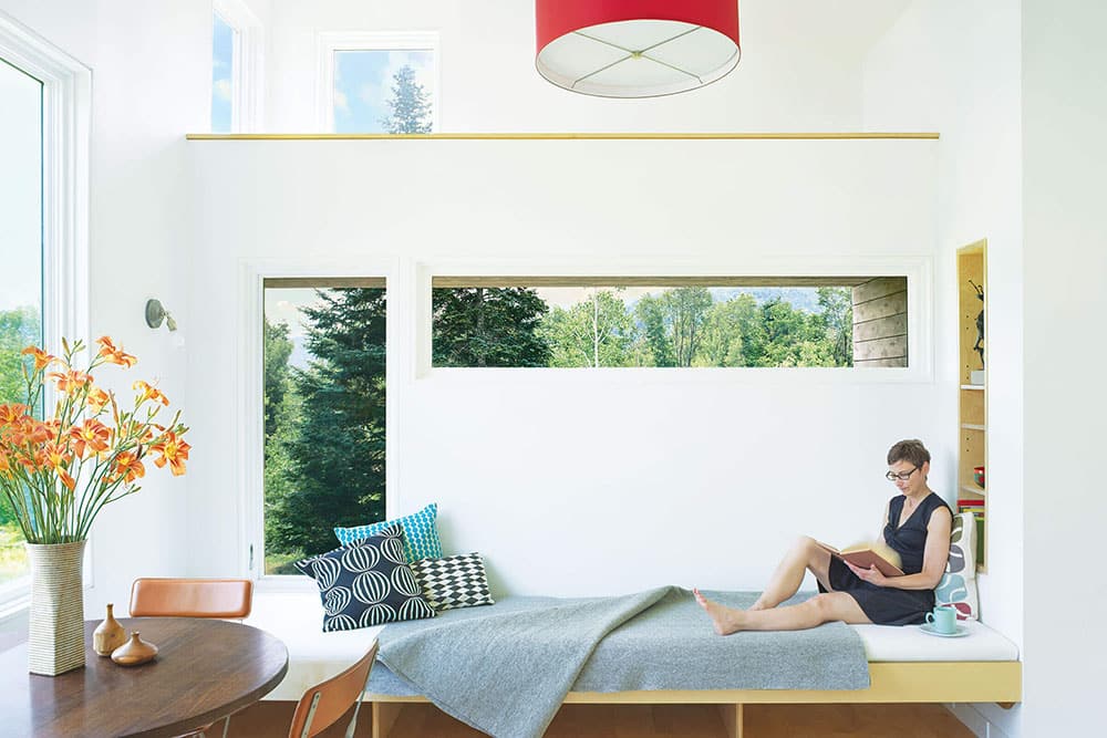 A person reading next to signature ultimate casement windows.