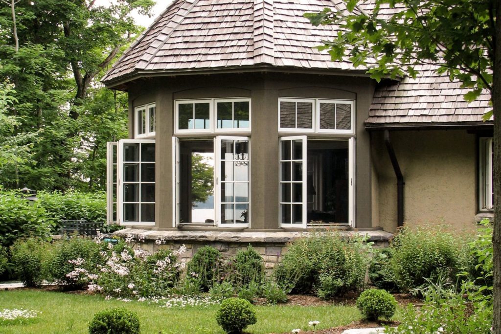 A brown rotunda with open french casement windows.